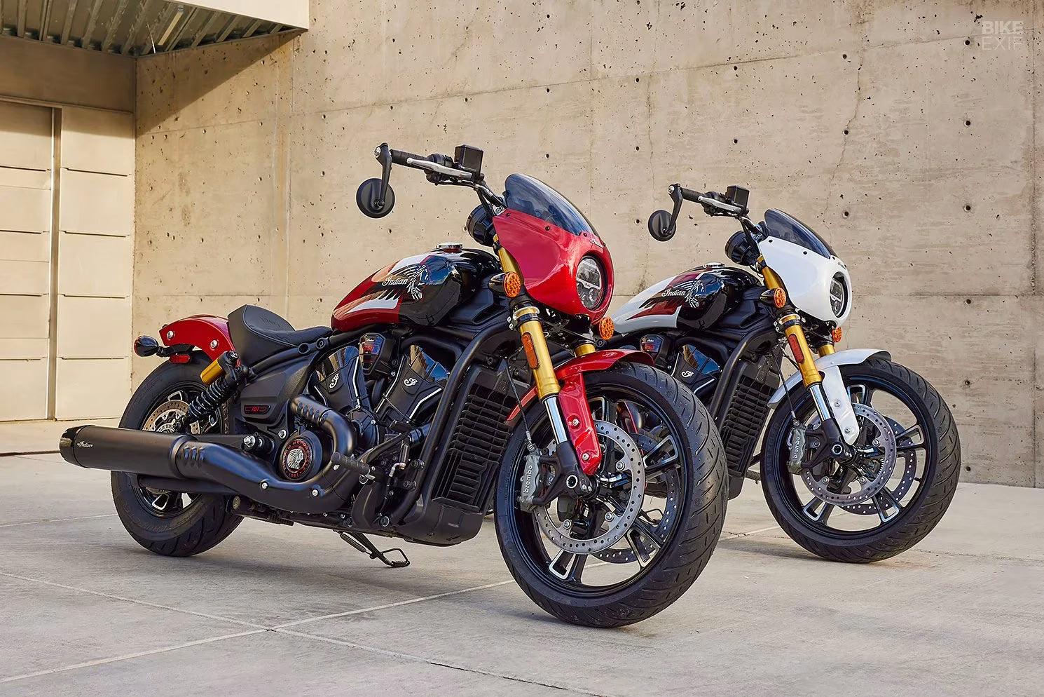 Indian motorcycles parked outside a brick workshop